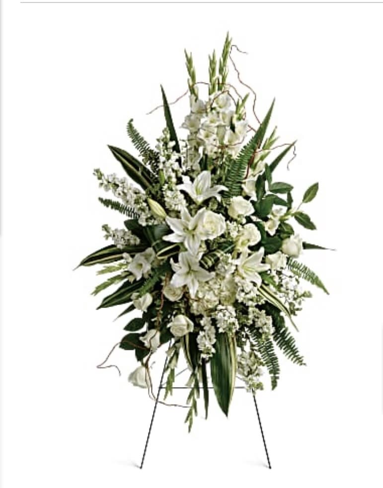 Tall white floral standing spray on an easel