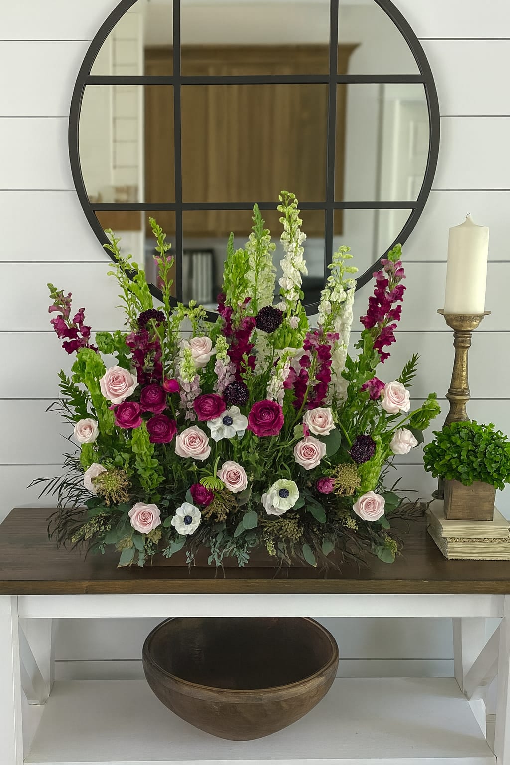 Tall floral arrangement with pink roses and magenta snapdragons in a low container