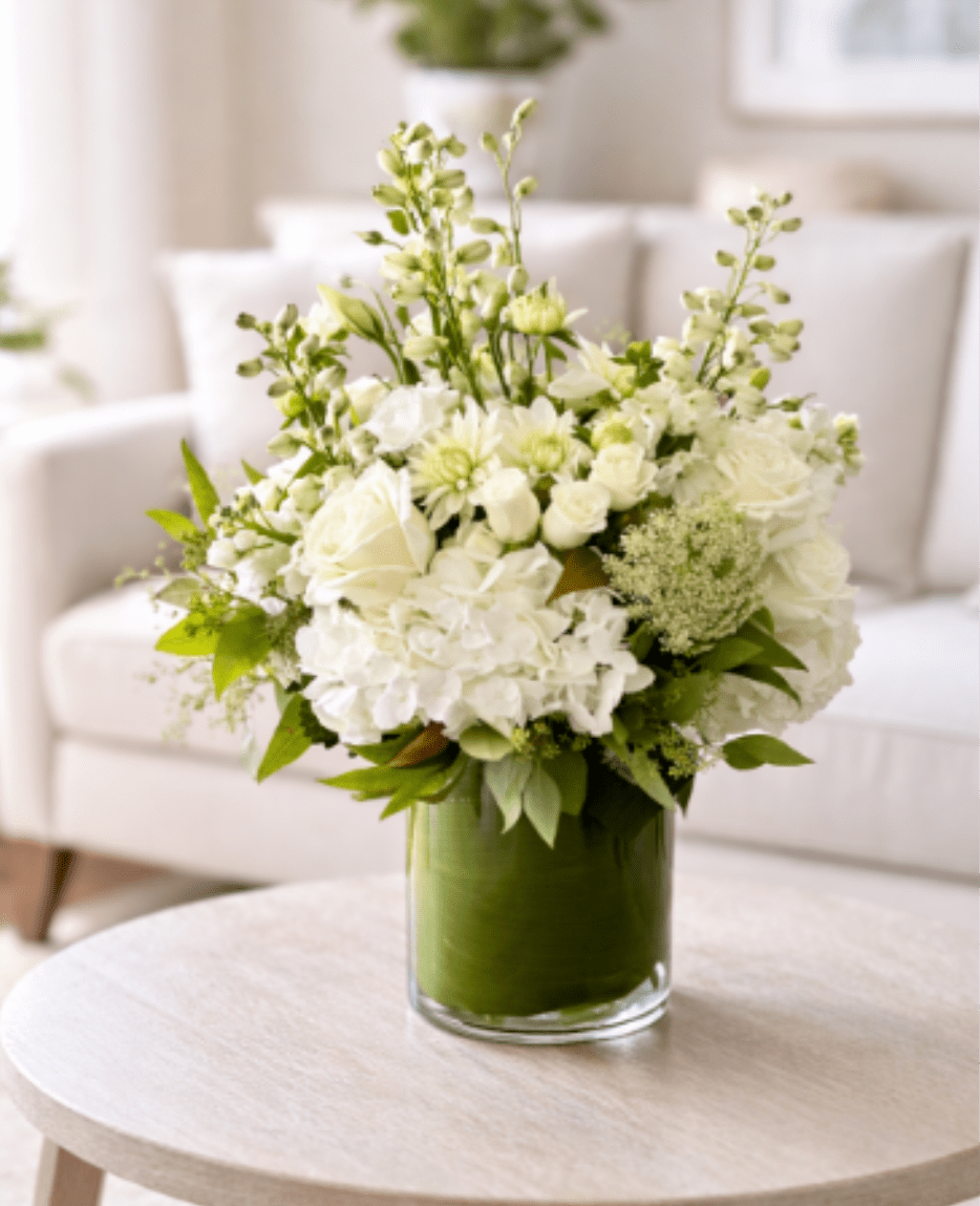 Palos Verdes  - The Palos Verdes Arrangement is a mix of white and green florals such as roses, hydrangeas, and greenery in a t leaf lined vase. 