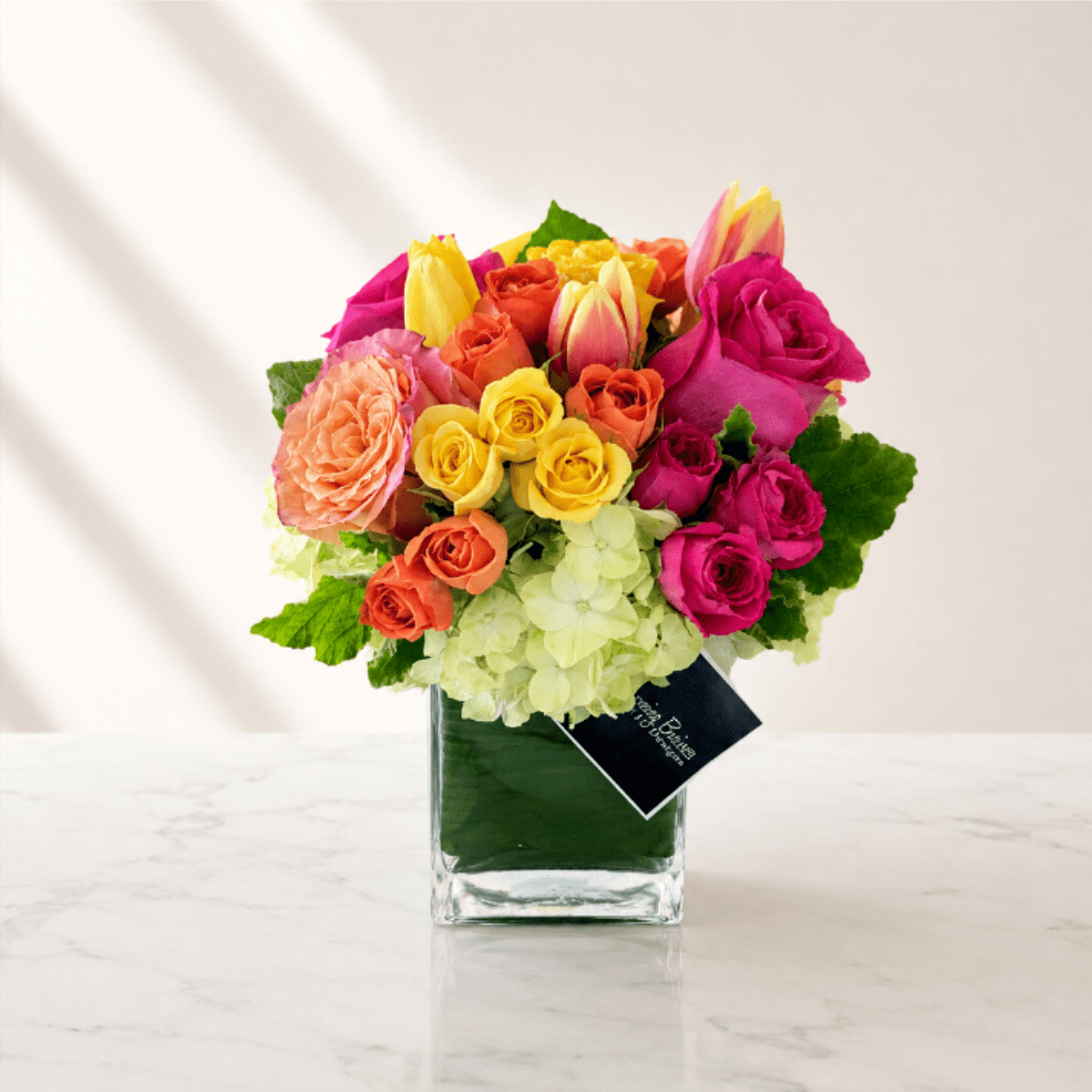 Olvera Arrangement by My Blooming Business  - Olvera Arrangement by My Blooming Business   Experience the vibrant heart of Los Angeles with the Olvera Arrangement by My Blooming Business. Inspired by the rich culture and colorful charm of Olvera Street, this bold and joyful bouquet features a stunning mix of orange, hot pink, and yellow roses, bright tulips, and soft hydrangeas, all artfully arranged in a sleek glass vase.  Perfect for celebrations, birthdays, thank-you gifts, or simply to brighten someone's day, the Olvera Arrangement captures the essence of Southern California sunshine and Mexican heritage.  As a top-rated florist based in Eagle Rock, Los Angeles, My Blooming Business proudly offers same-day flower delivery to all of Downtown LA, Glendale, Pasadena, Silver Lake, Highland Park, and surrounding neighborhoods.  Order the Olvera Arrangement today and bring a piece of Los Angeles history into your home.  Top-rated florist in Los Angeles on Google, Yelp, BloomNation, and DoorDash.         