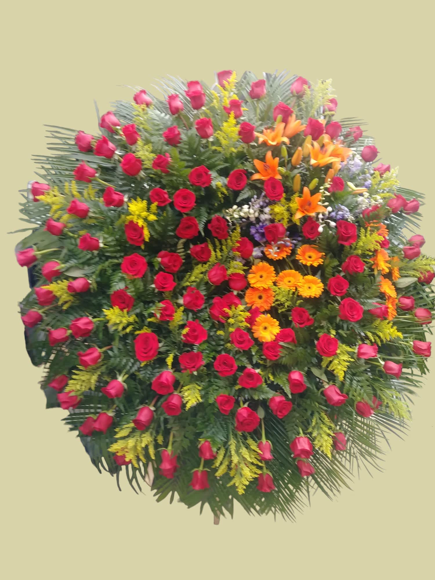 Large standing spray of red roses with orange lilies and yellow filler flowers