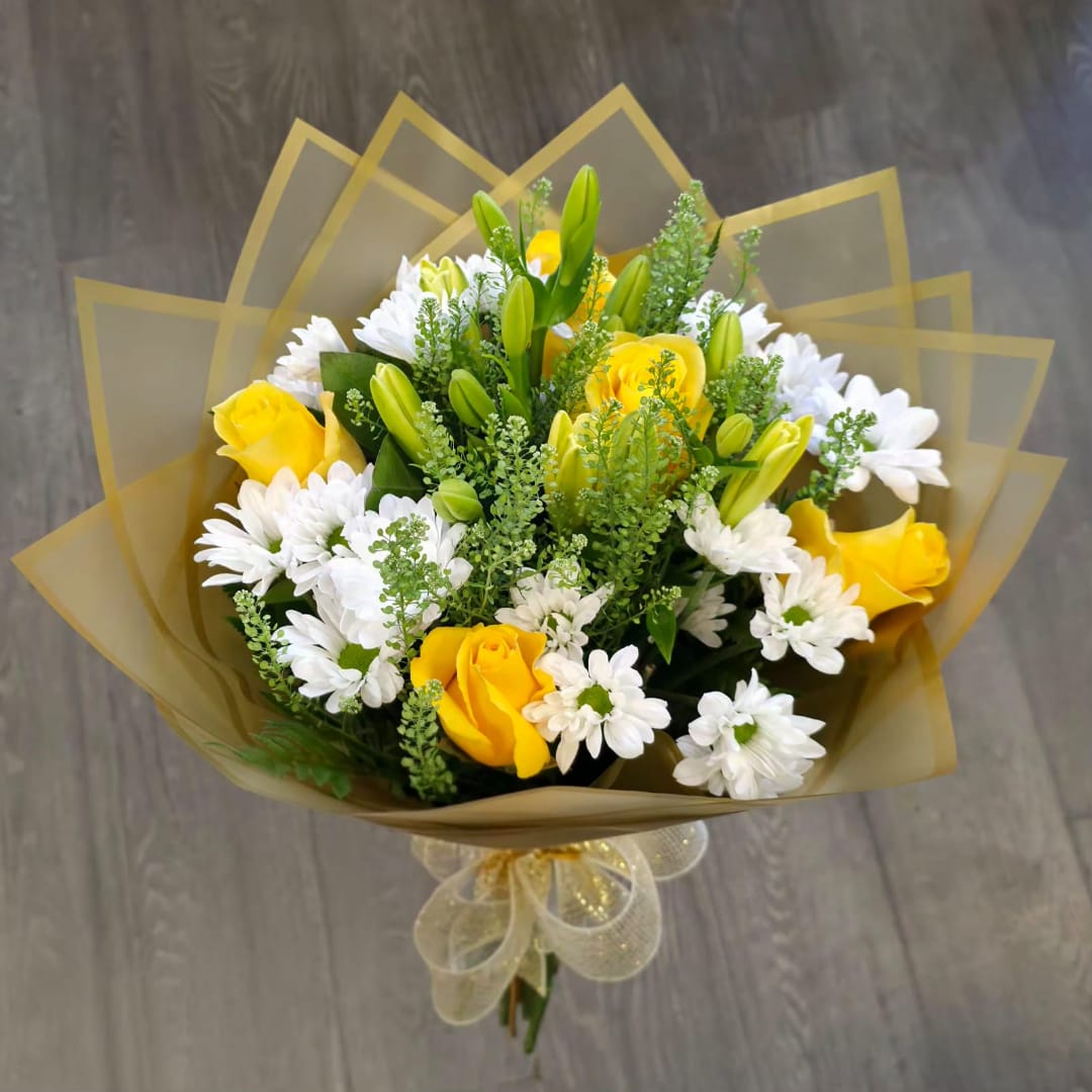 Yellow roses and white daisies bouquet wrapped in gold paper