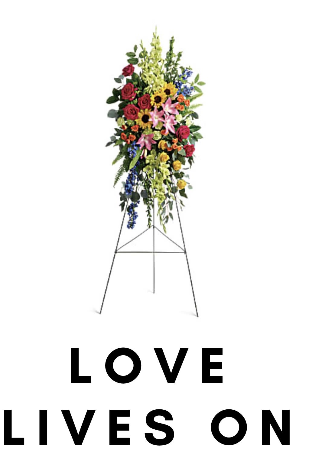 Standing floral spray with mixed flowers on an easel