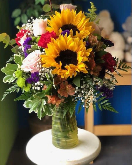 My Ray Of Sun  - (ONE-SIDED) Beautiful sunflowers surrounded by pink roses and colorful flowers in a yellow tall vase.