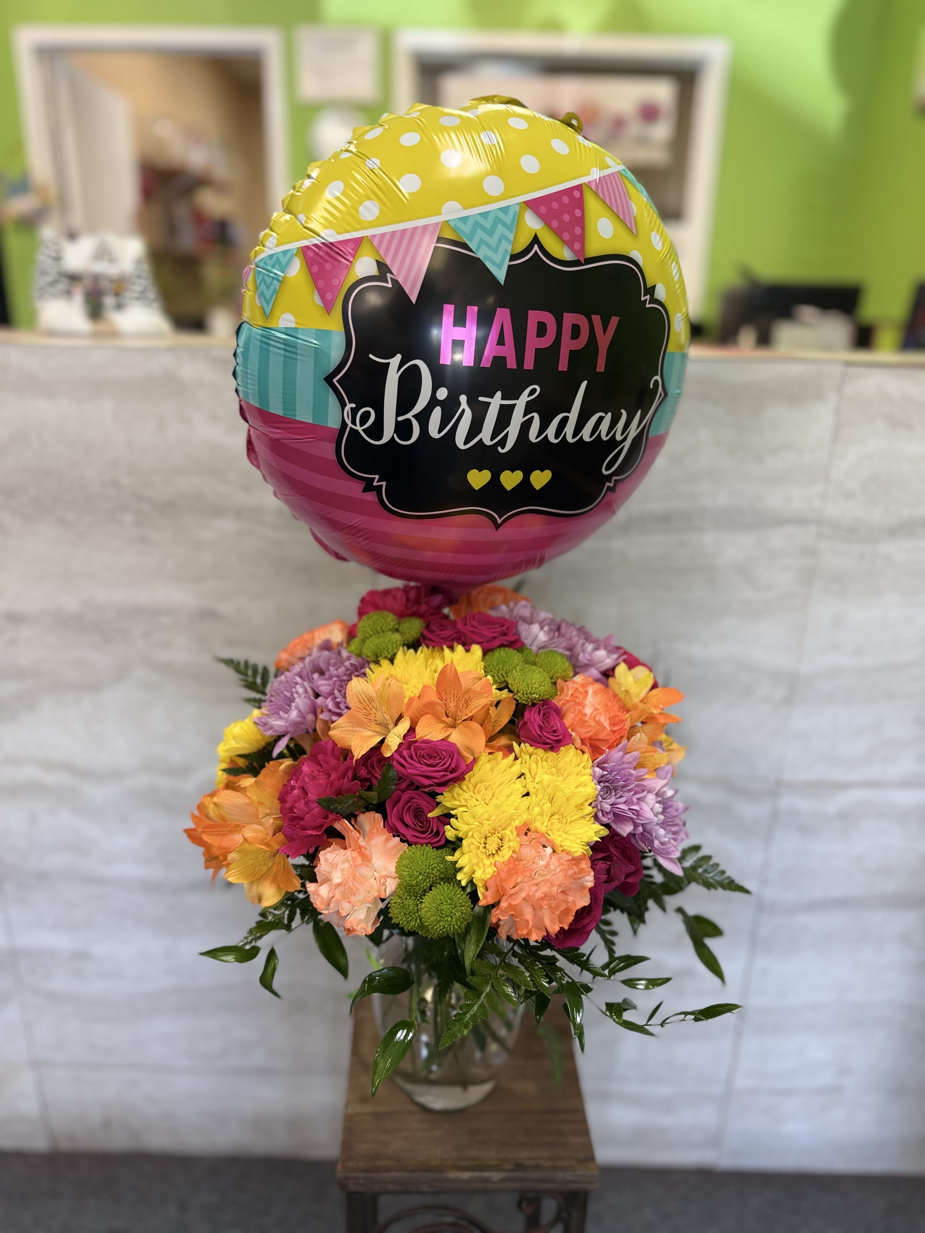 A Year Brighter  - A bright, cheerful mix of colorful blooms designed to celebrate joy, happiness, and special moments. 