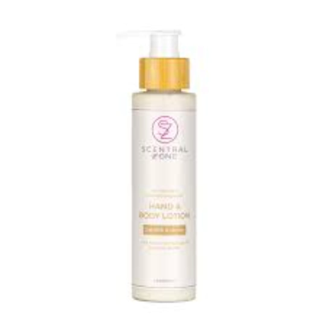 Bottle of Scentsy body lotion with a gold cap on a white background