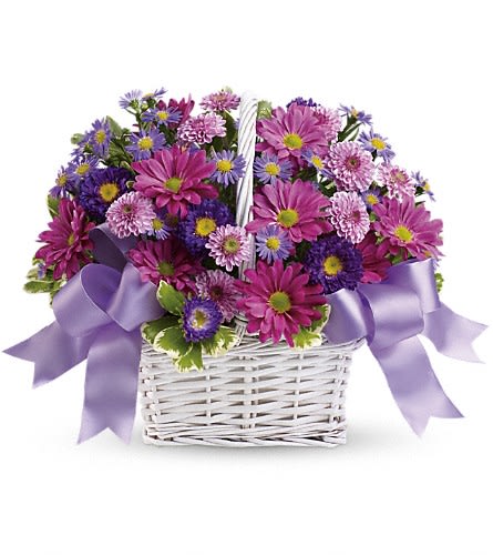 Basket of pink and purple daisies with lavender ribbon