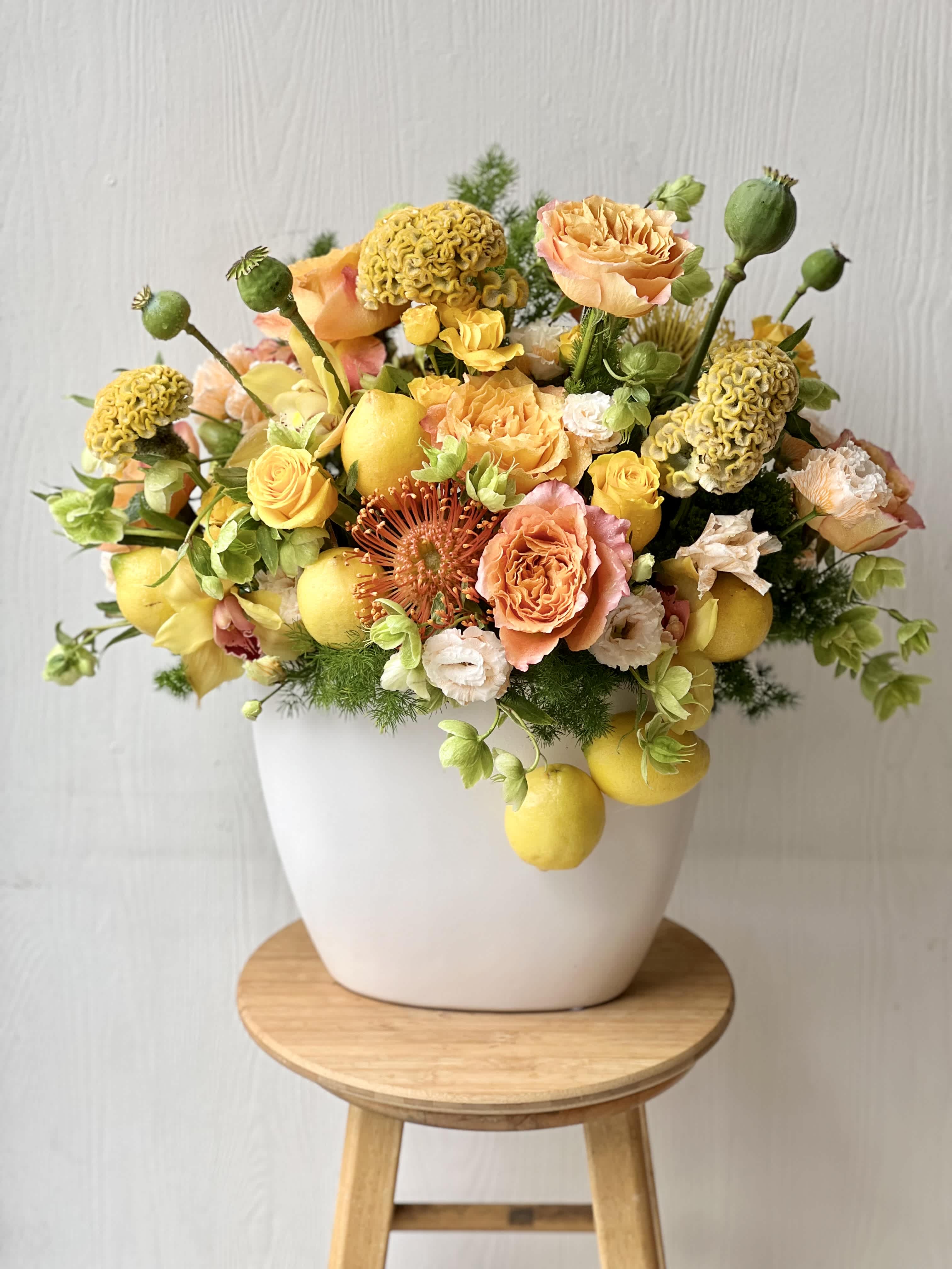 EC111 Citrus Blossom -  Citrus Blossom – Vibrant Yellow &amp; Orange Floral Arrangement with Fresh Lemons | Same-Day Flower Delivery in Tustin, Irvine, Newport beacch , and Costa Mesa. Bring a burst of sunshine and elegance to any space with our Citrus Blossom arrangement — a bold and refreshing blend of premium blooms and real citrus accents. Designed to energize and uplift, this unique bouquet features fresh yellow lemons, vibrant yellow and orange roses, spray roses, cymbidium orchids, pink pincushion protea, cockscomb, hellebore, lisianthus, and seasonal greenery. The Citrus Blossom arrangement is perfect for birthdays, celebrations, thank-you gifts, or as a bright statement piece in your home or office. The combination of fresh citrus and colorful flowers adds a modern twist to classic beauty — cheerful, sophisticated, and truly unforgettable.  Why Choose Citrus Blossom:  Unique mix of fresh lemons and premium florals in yellow, orange, pink, and green, Features roses, orchids, protea, lisianthus, cockscomb, and more  Hand-arranged in a stylish, modern vase,Perfect for celebrations, hospitality gifts, or brightening someone’s day  Same-day flower delivery available in Tustin, Irvine,New port ,Costa Mesa,and surrounding Orange County areas  Send joy with Citrus Blossom, exclusively from Everyday Creations — your trusted local florist in Tustin, CA, proudly serving the Tustin–Irvine area with handcrafted floral designs and prompt, reliable delivery.  