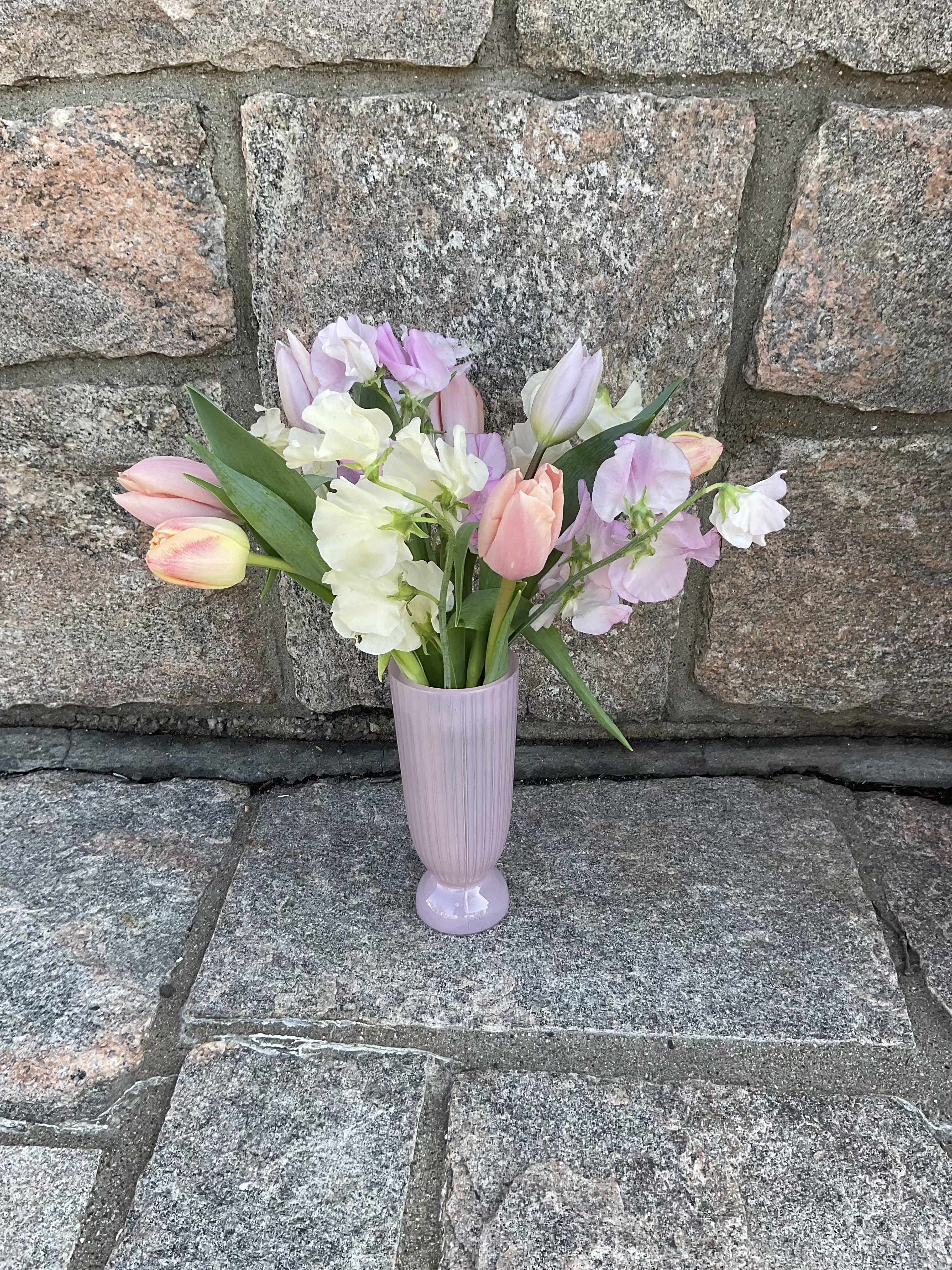 Pastel tulips and sweet peas in a lavender vase