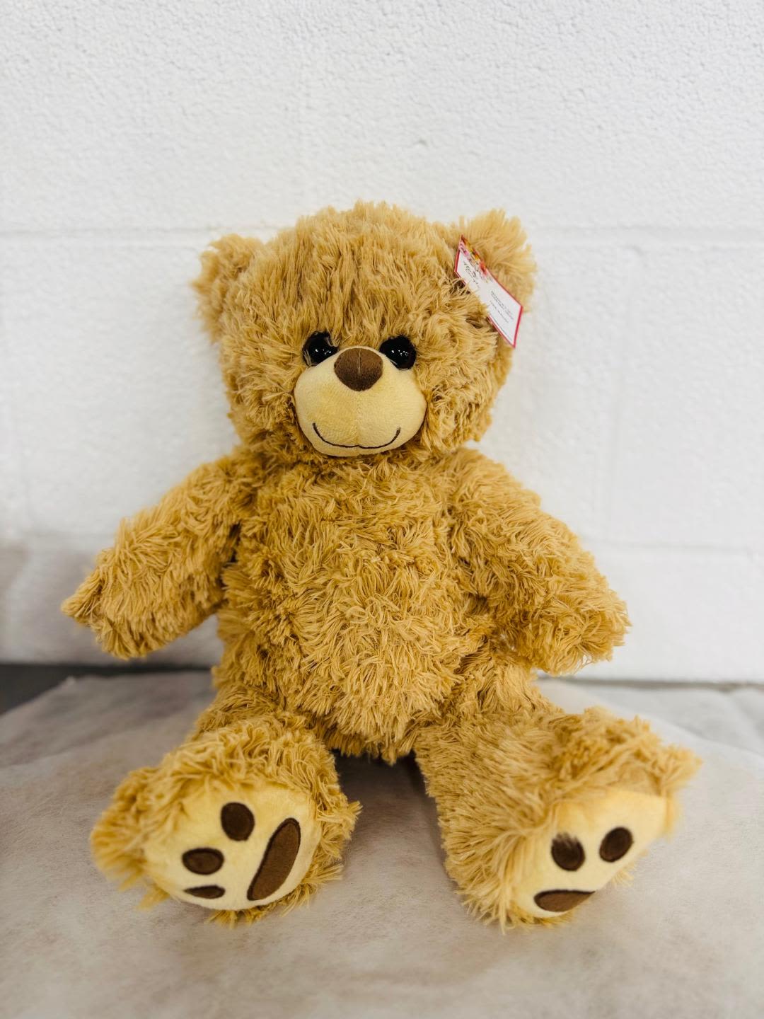 Plush teddy bear sitting on a light surface
