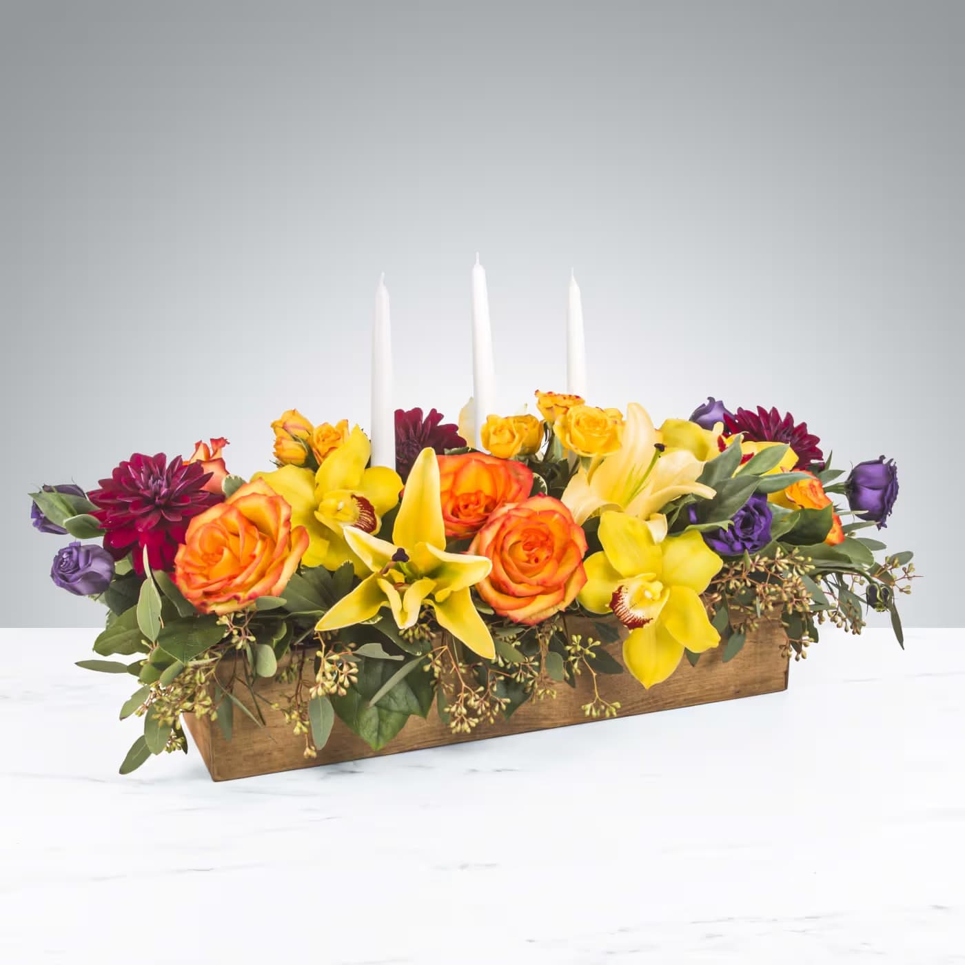 Full Harvest by BloomNation™ - No dinner party or food gathering is complete without a centerpiece and this large arrangement makes a big statement on any table. Featuring white dinner candles and a variety of flowers, dress up any event with this arrangement. Send it as a housewarming or thank you gift.   APPROXIMATE DIMENSIONS 25" W X 14" H