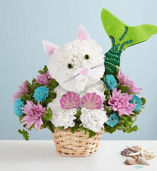 Basket arrangement shaped like a white cat with pink ears and a green tail