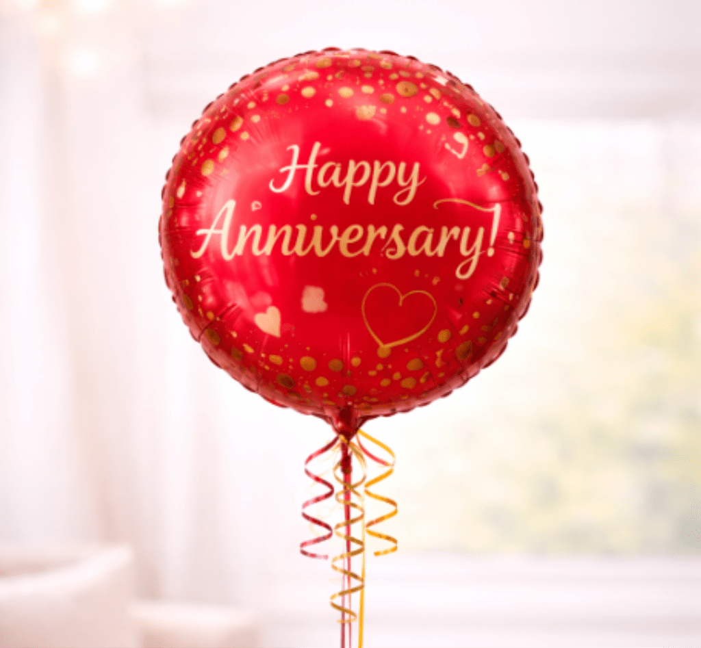 Red anniversary balloon with gold confetti and ribbon curls