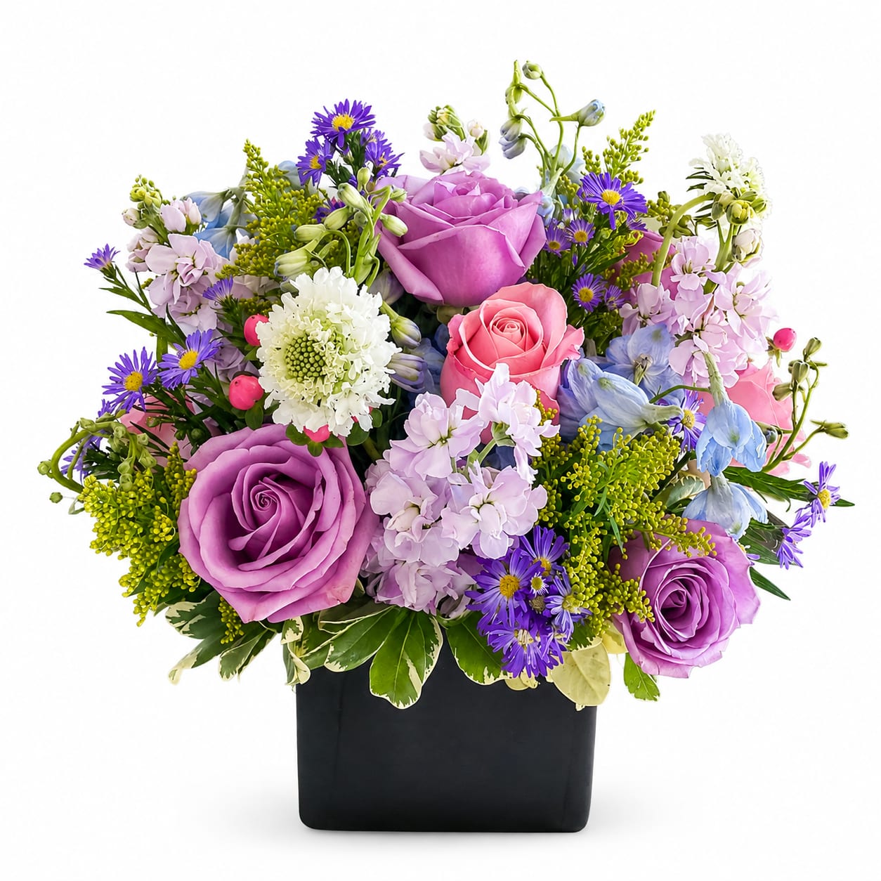 Mixed bouquet of purple, pink, and blue flowers in a black vase