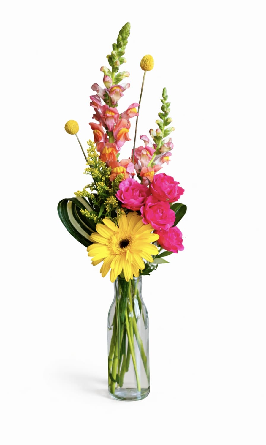 Bright mixed bouquet in a clear glass vase with yellow and pink blooms