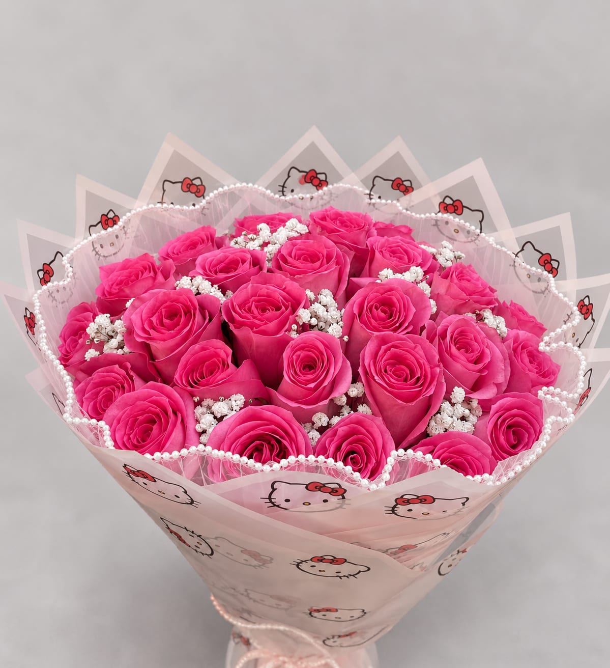 Bouquet of bright pink roses wrapped in Hello Kitty paper