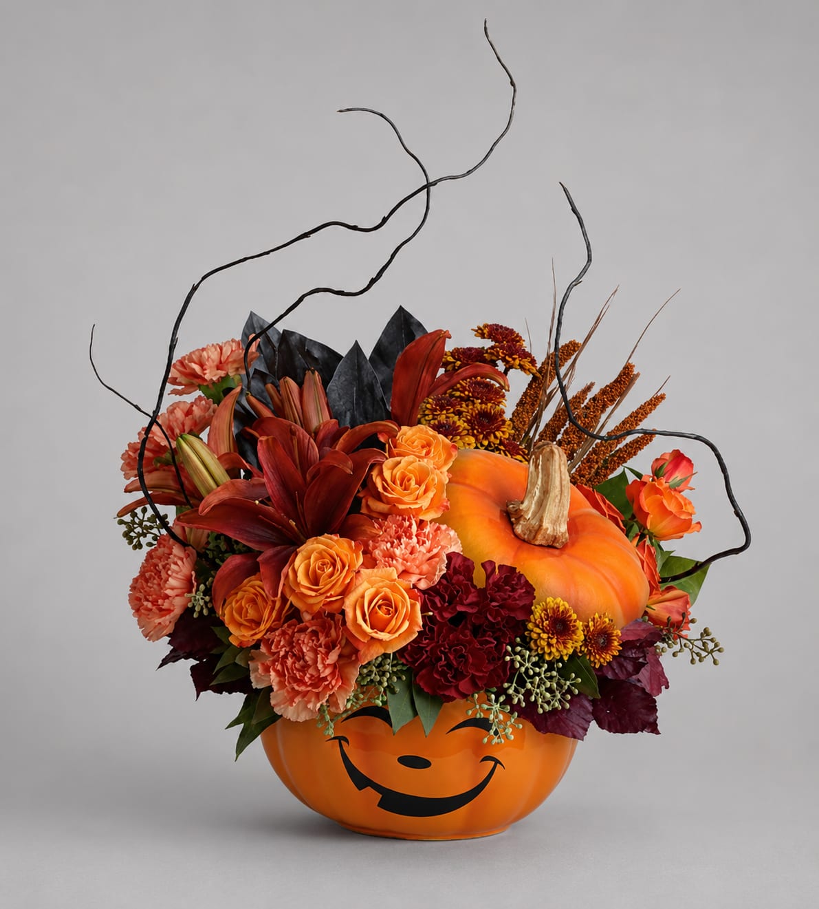 Halloween pumpkin container filled with orange and red flowers