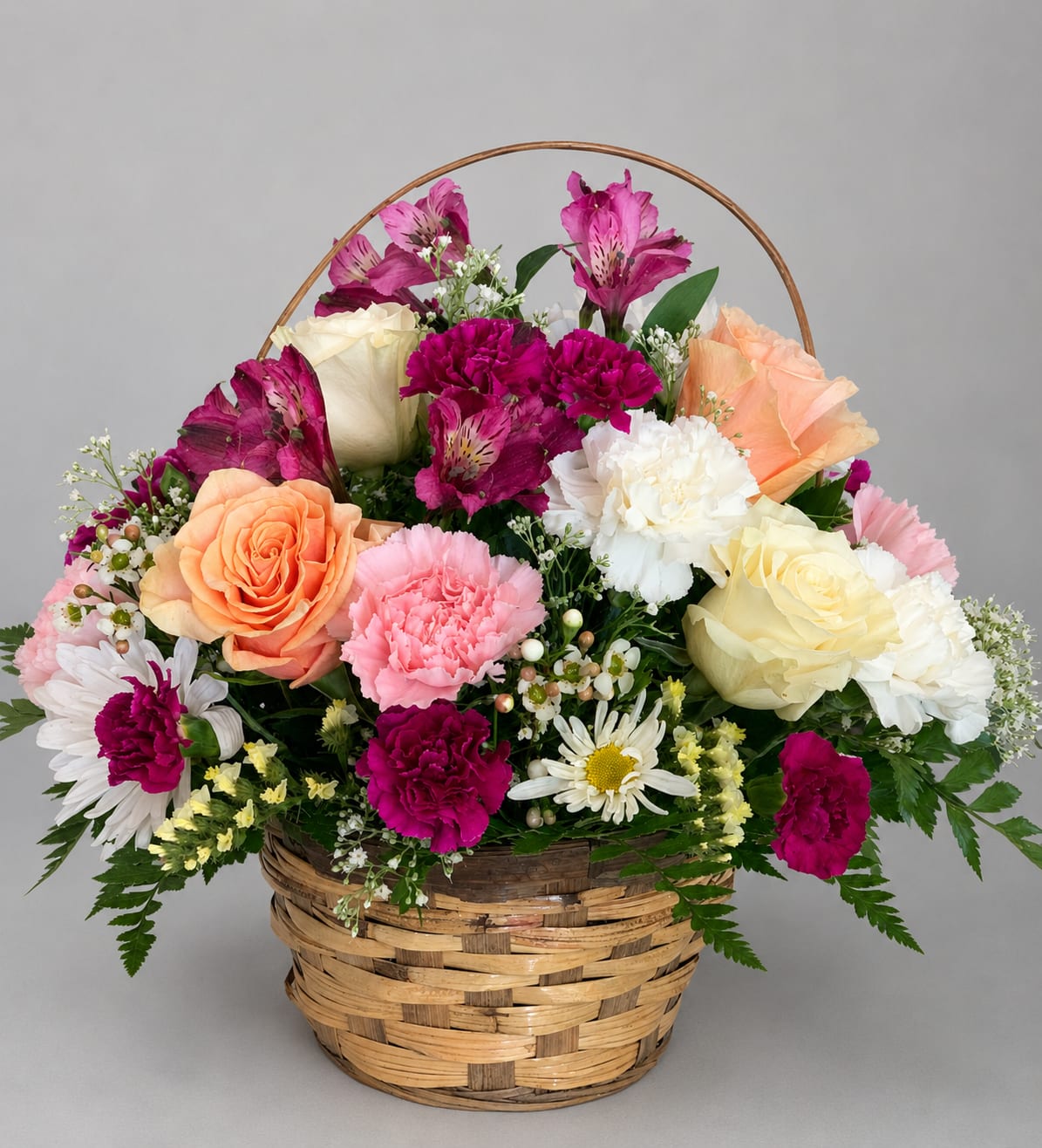 Basket arrangement of roses, carnations, daisies, and alstroemeria