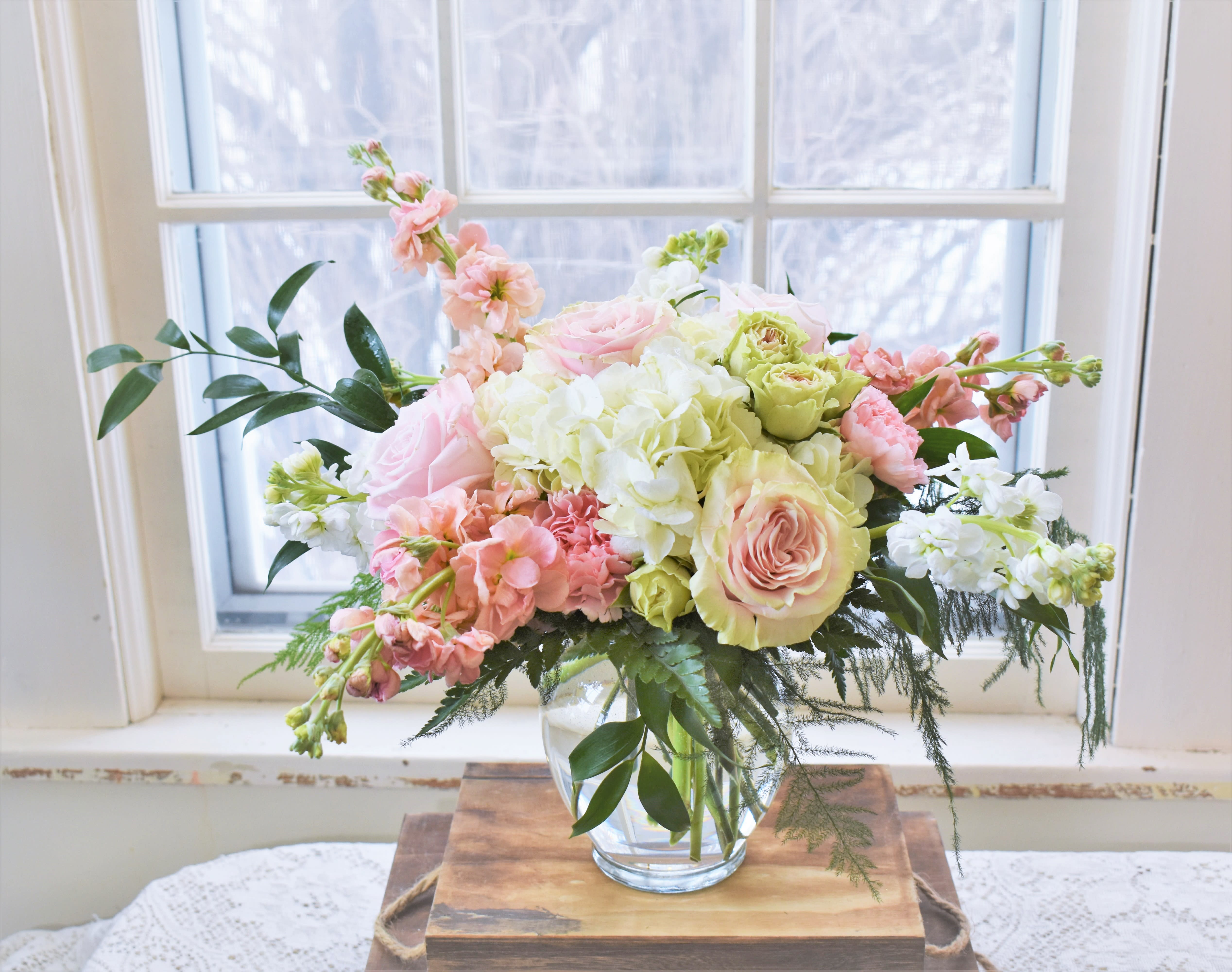 Sweet Thoughts - The soft textures of Hydrangea, stock, roses, and spray roses in blush and white hues are designed in a vase and accented by lush greenery. Perfect to celebrate any occasion! 