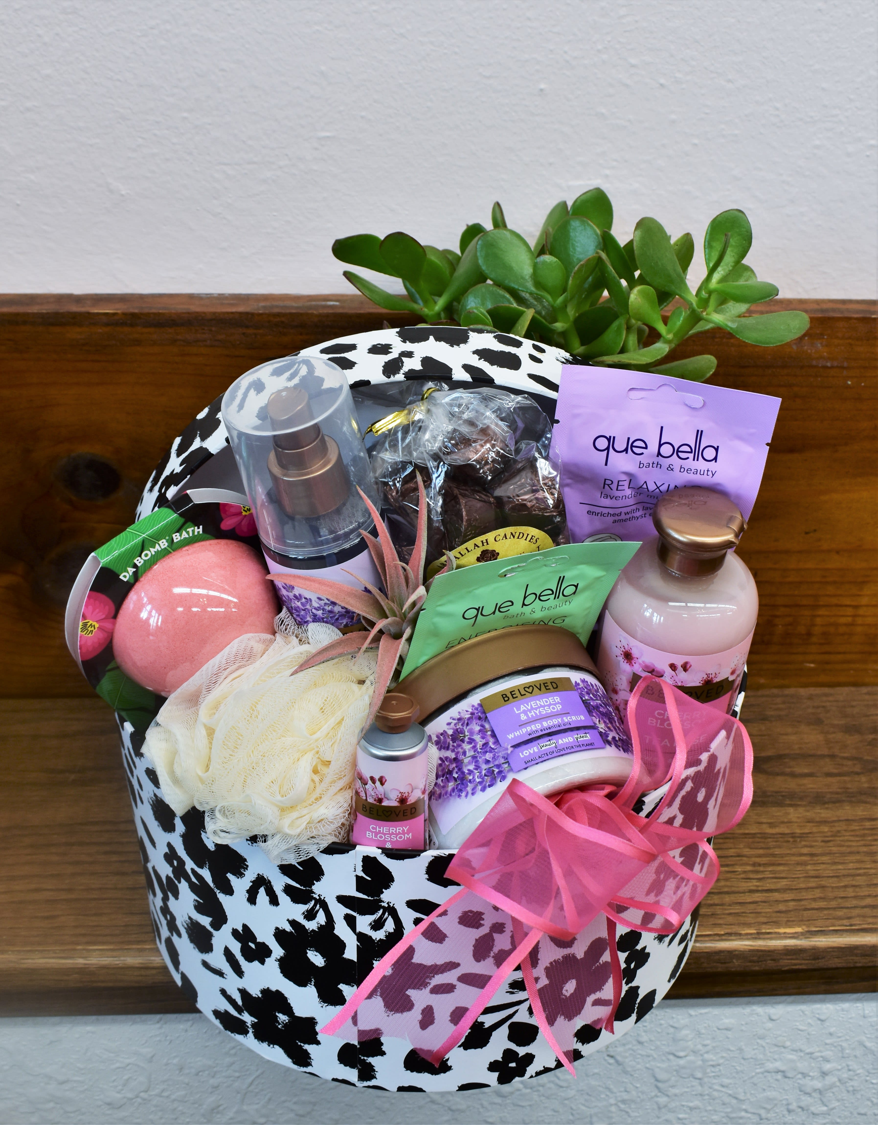 Gift basket with bath products and a small succulent arrangement