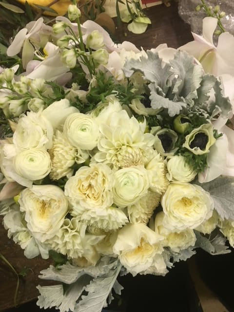 Designer's Choice - White Glamour - Sophisticated medley in white and silver hues, presented in a 8"x8" clear glass or ceramic vessel.  *Each arrangement is unique and ingredients may vary slightly. Floral designers will preserve the overall shape, size, style, and color scheme.