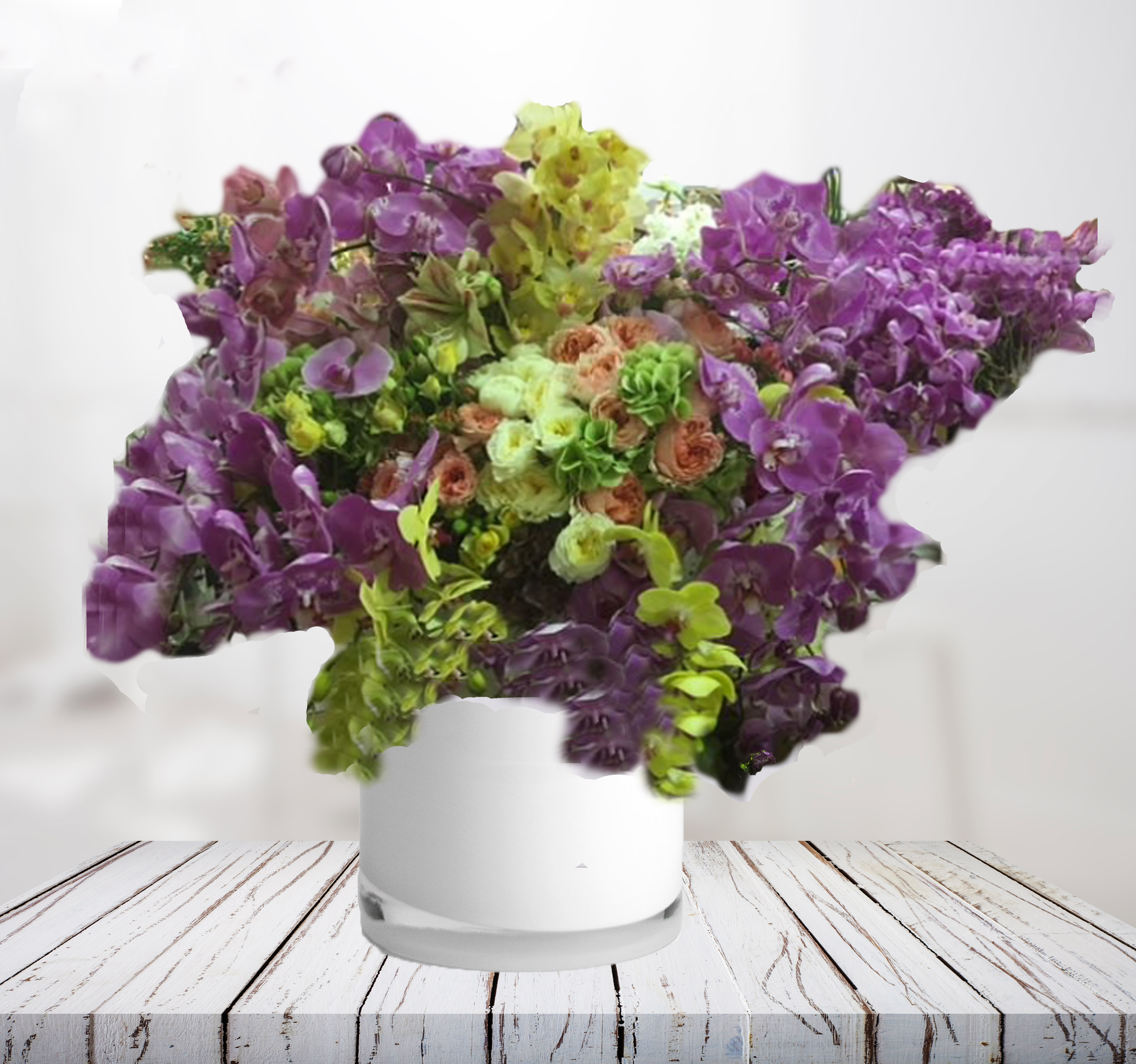 Purple and green orchid arrangement in a white vase