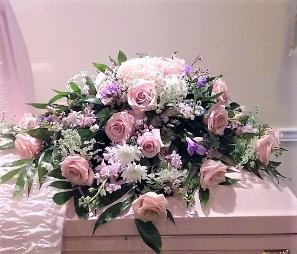 Soft and Lovely 1/2 Casket Spray - A soft design of roses,hydrangeas,lavender filler flowers and cushions