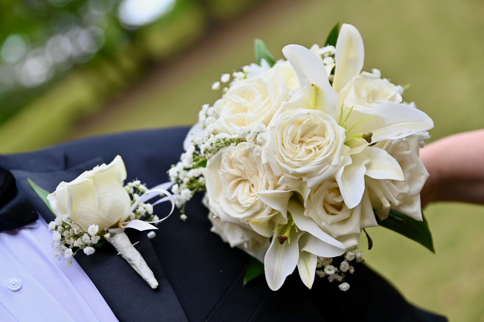 Roses and Lilies Handheld - This is an elegant handheld bouquet, perfect for proms, weddings, graduation, or homecoming.