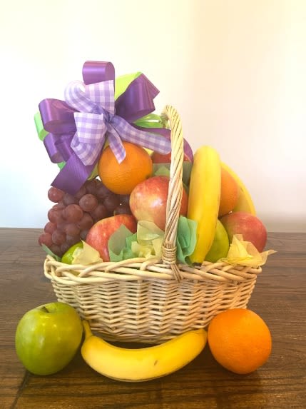 Gourmet Fruit Basket - A beautiful and colorful fresh fruit basket featuring a hand-selected assortment of premium fruits, elegantly arranged in a woven basket and finished with a decorative ribbon. Perfect for gifting, celebrations, thank-you gifts, get-well wishes, corporate events, or everyday enjoyment.  Includes: Crisp Apples Juicy Oranges Fresh Bananas Sweet Grapes Delicious Pears Seasonal Fruit (Store's Choice)  Each basket is carefully handcrafted and may vary slightly based on seasonal availability to ensure the freshest quality fruit. A thoughtful, healthy gift suitable for any occasion.   Substitution Policy: If certain fruits are unavailable, the shop may substitute them with similar seasonal fruits of equal or greater value.