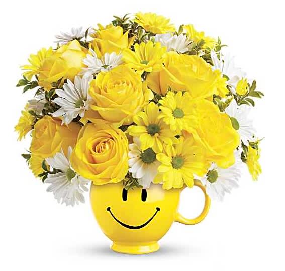 Yellow roses and white daisies in a smiley-face mug