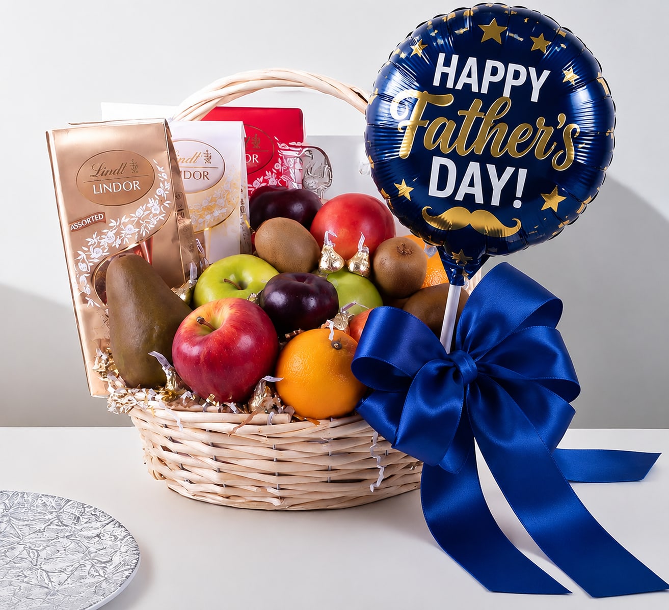 Fruit &amp; Chocolate Basket for DAD - A gift basket filled with fresh fruit and chocolates. The basket contains apples, oranges, pears, plums, kiwi, and chocolates. It is decorated with a large red ribbon and presented in a woven wicker basket with a handle. Perfect for gifting on special occasions.