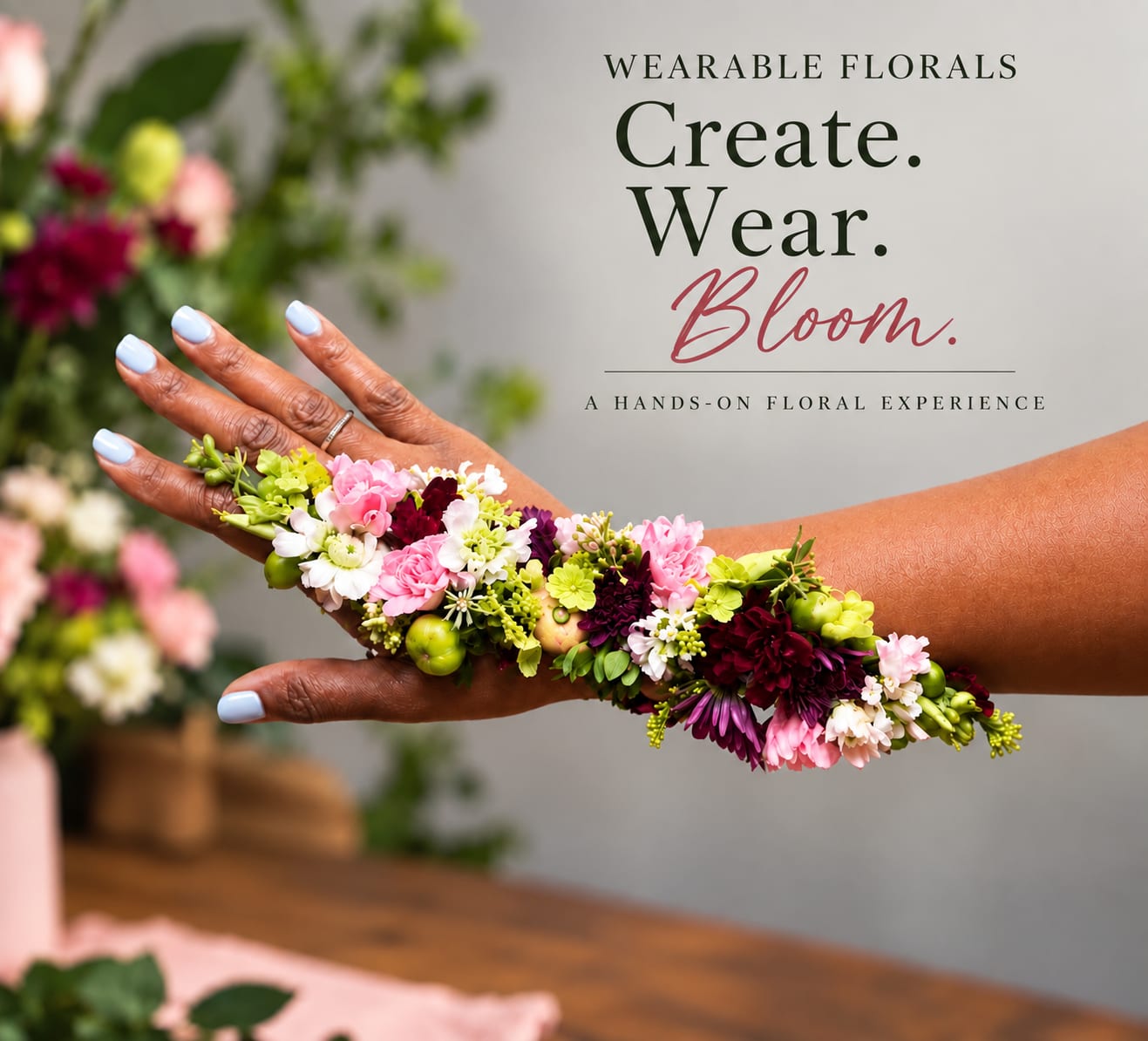 Hands wearing a floral wrist cuff with pink, white, and green flowers