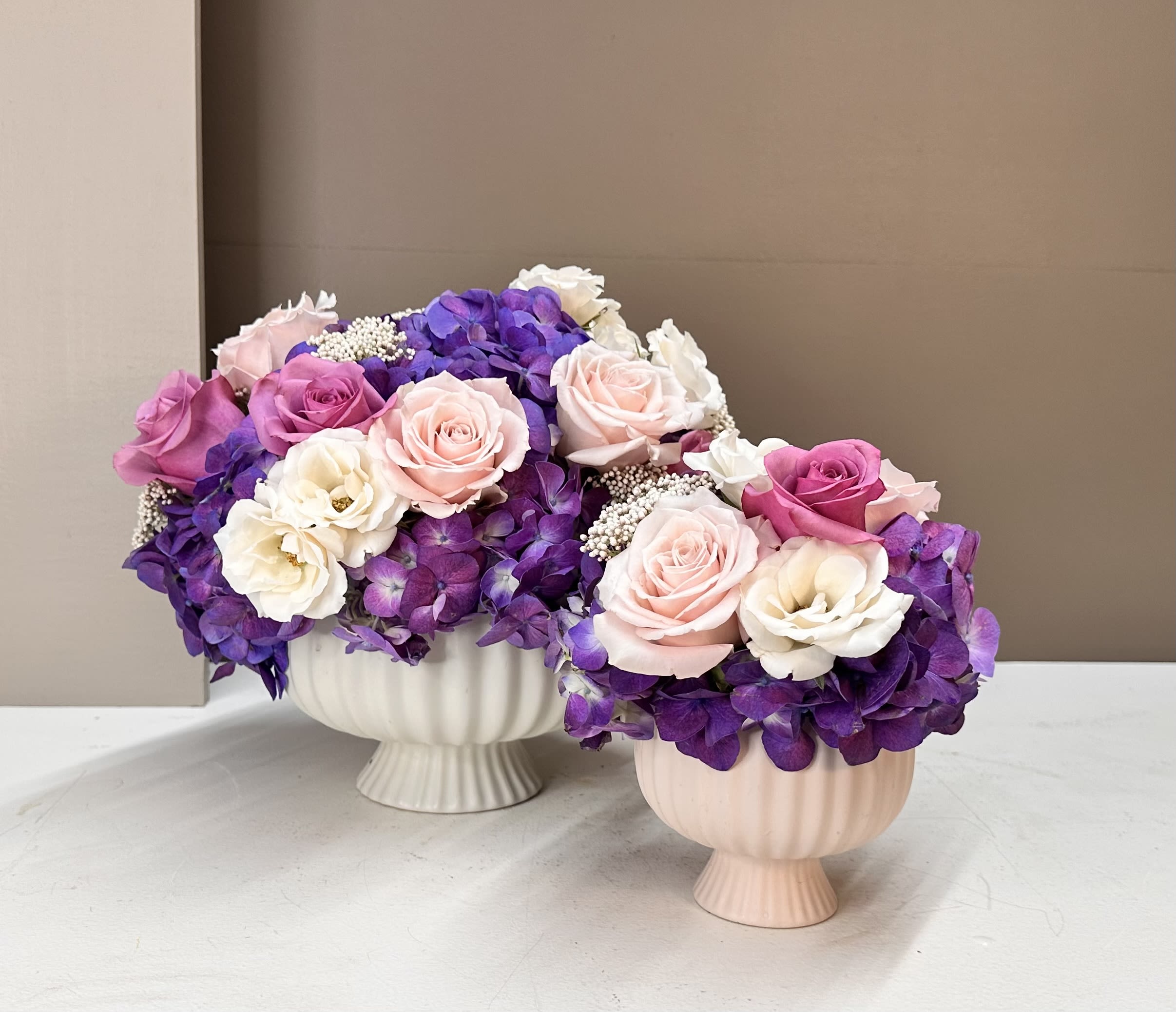 Mommy &amp; Me - A sweet and sophisticated duo designed to be enjoyed together. Featuring soft Blush, Cream, Lavender, and deep Purple blooms in matching vessels, the Mommy and Me set pairs a full‑size arrangement with a petite companion—perfect for celebrating special bonds, sharing a gift with a loved one, or styling two spaces with coordinated elegance.