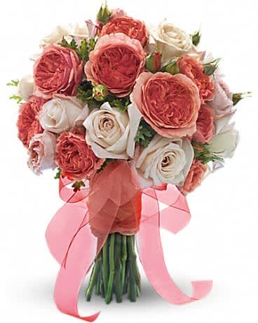 Bouquet of pink and white roses tied with a pink ribbon