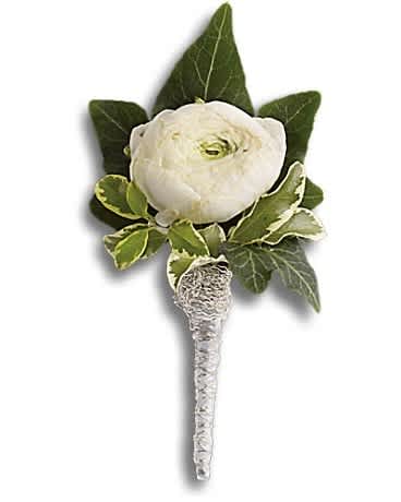 White flower boutonniere with green leaves and silver-wrapped stem