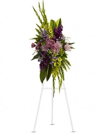 Tall purple and green floral standing spray on an easel
