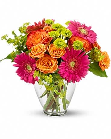 Bouquet of orange roses and pink gerbera daisies in a clear glass vase