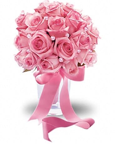 Pink rose bouquet in a clear vase with a ribbon