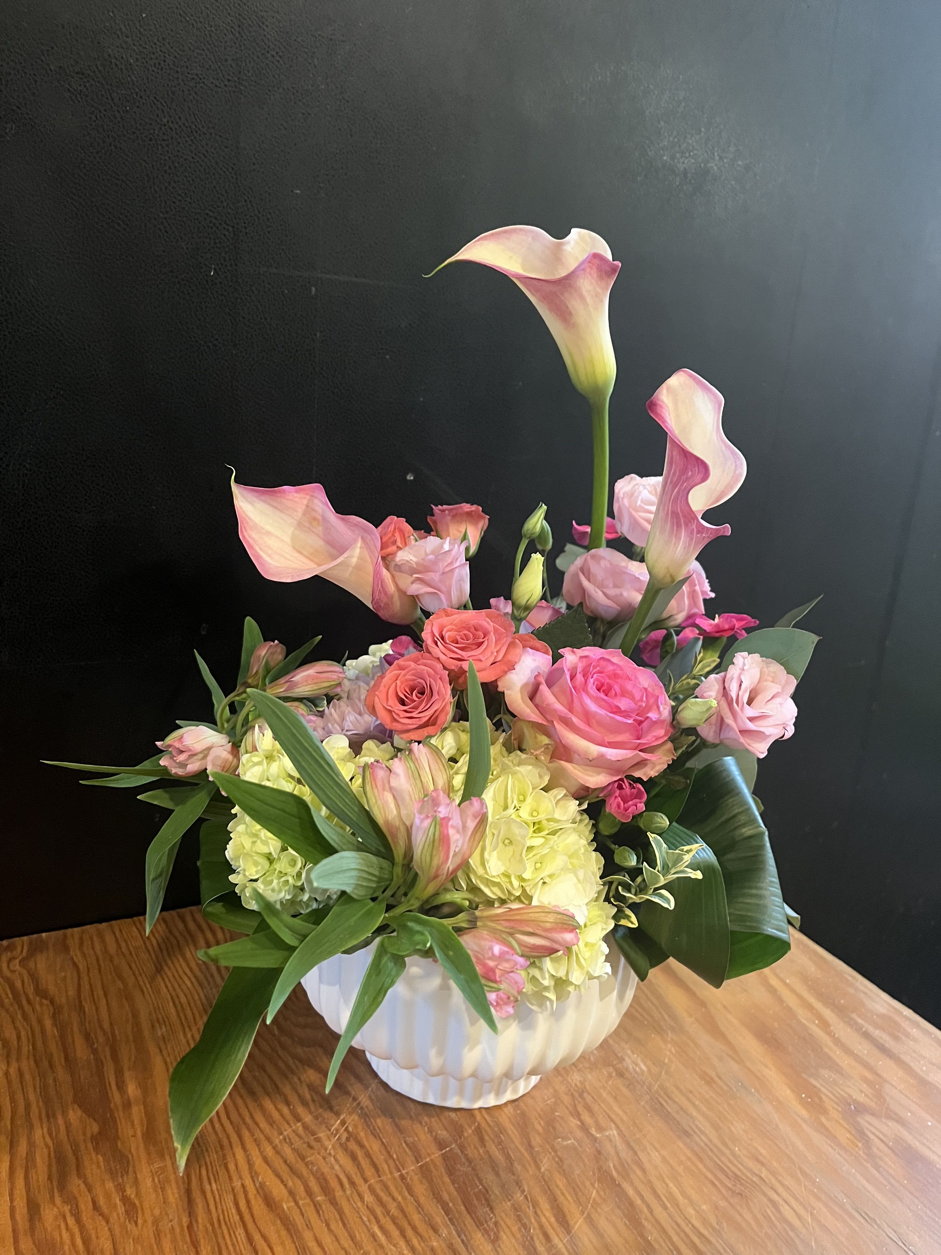 Pink Whisper - An elegant Ikebana style arrangement that reaches new heights — soft pinks and creamy blooms beautifully balanced in a chic geometric vase. Perfect for any occasion 