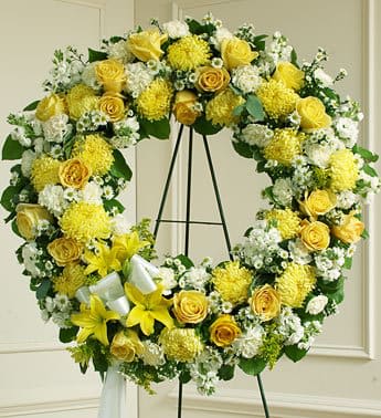Yellow and white floral wreath on a black easel