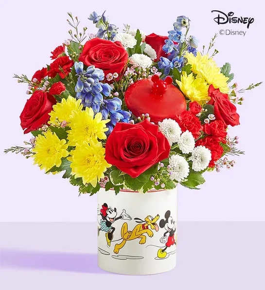 Colorful bouquet of roses, chrysanthemums, and blue flowers in a Disney Mickey and Friends container