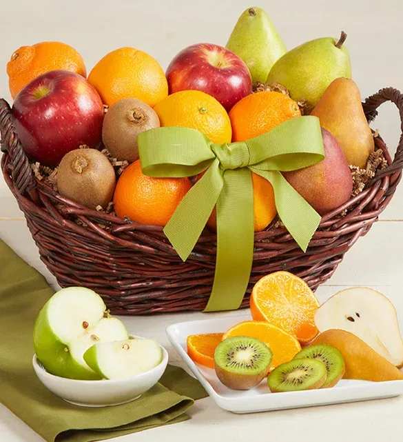 Fruit basket with apples, pears, oranges, and kiwi slices tied with a green ribbon