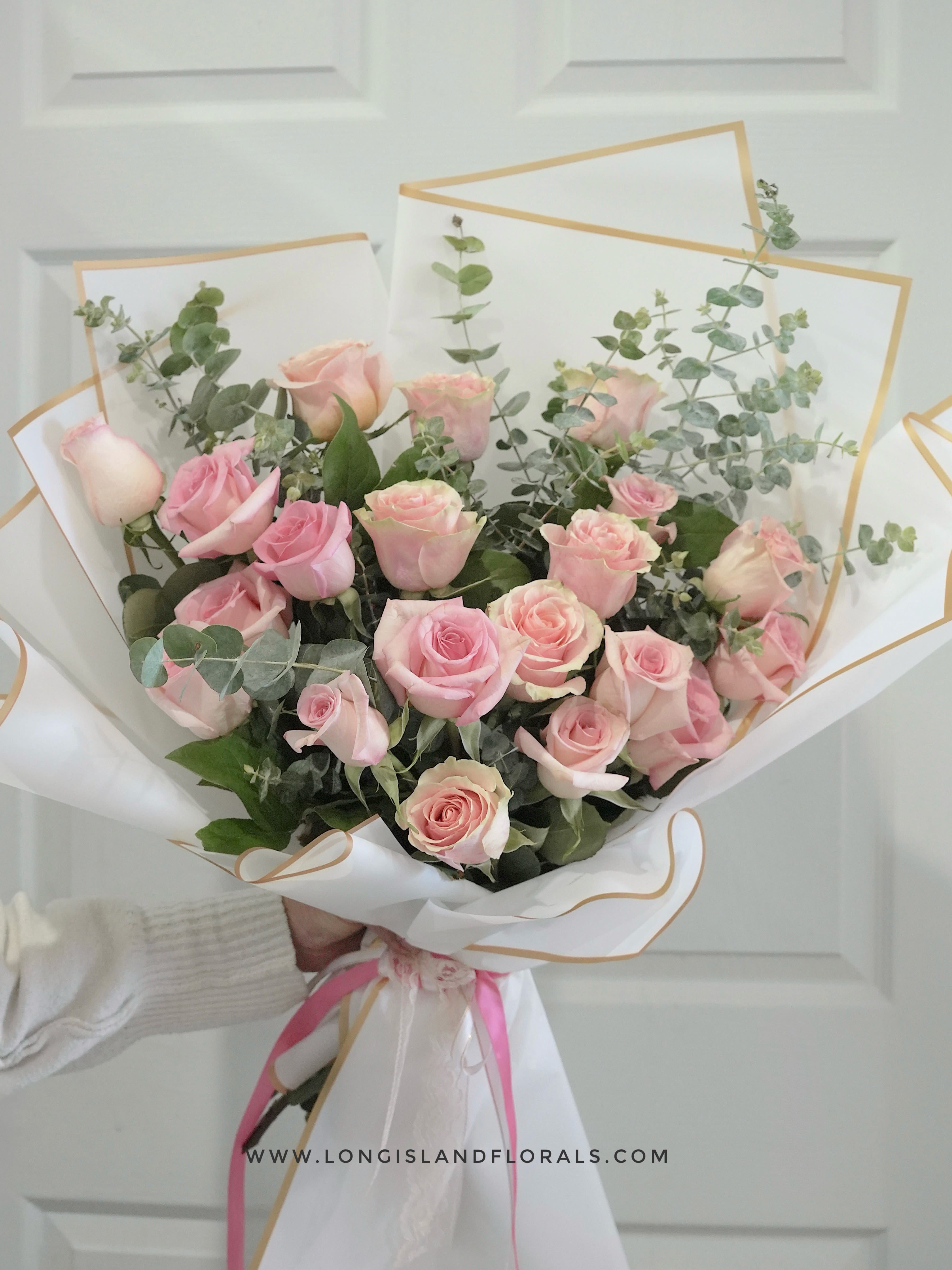 Pink Rose Elegance Bouquet - A dense cluster of  pink roses forms a rounded hand-tied bouquet that reads as quietly romantic and effortlessly elegant - perfect as an anniversary bouquet, birthday bouquet, or a love-and-romance gift. The soft blush roses pair with airy eucalyptus to create a fresh, garden-inspired scent and a silvery-green contrast that makes the pink tones glow, so the person you're thinking of will feel genuinely celebrated and seen. 