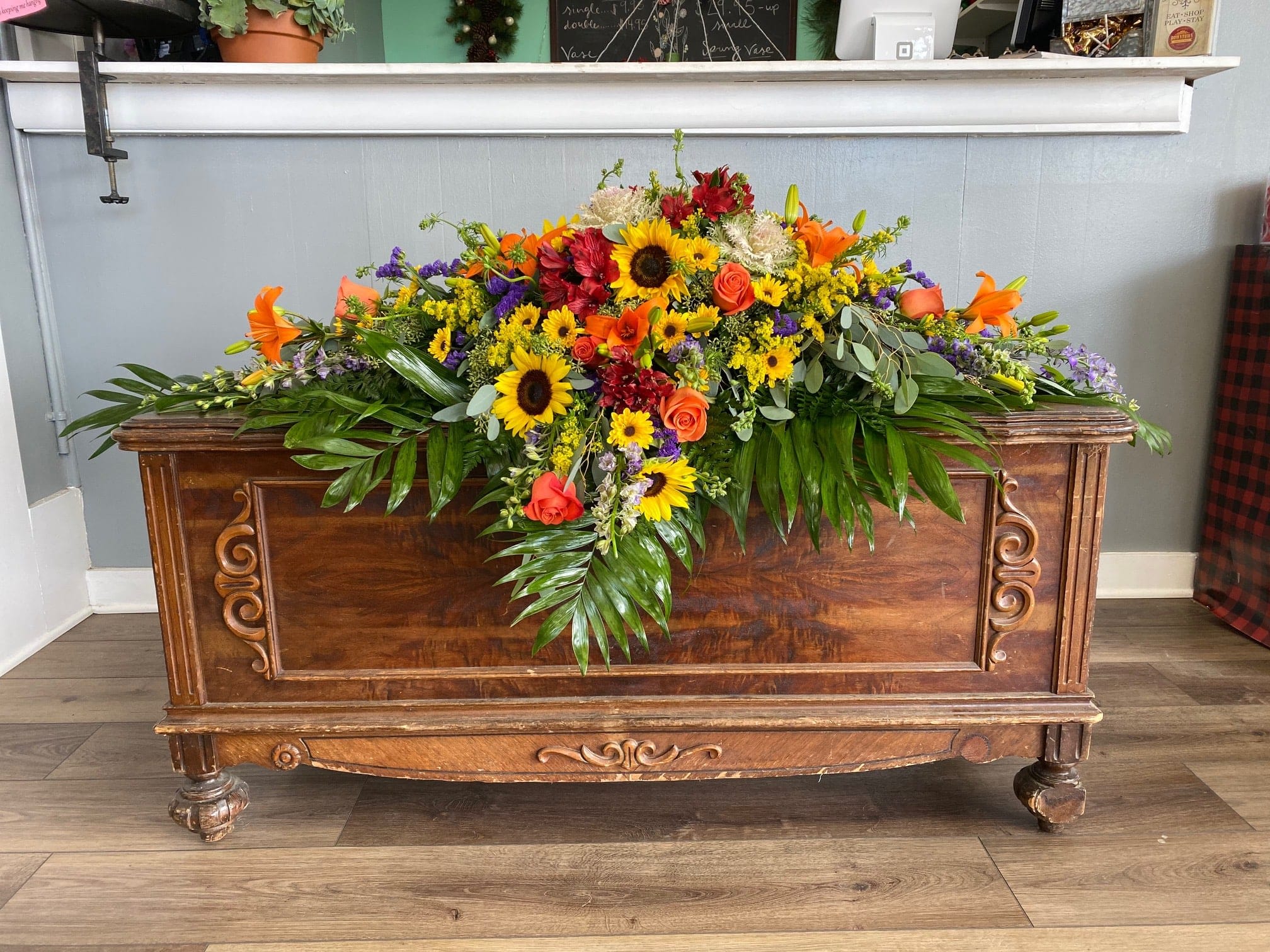 Large casket spray with sunflowers, roses, and lilies