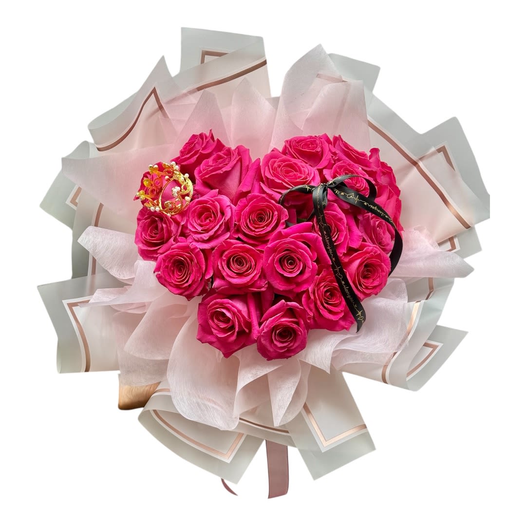 Bouquet of bright pink roses wrapped in pale paper