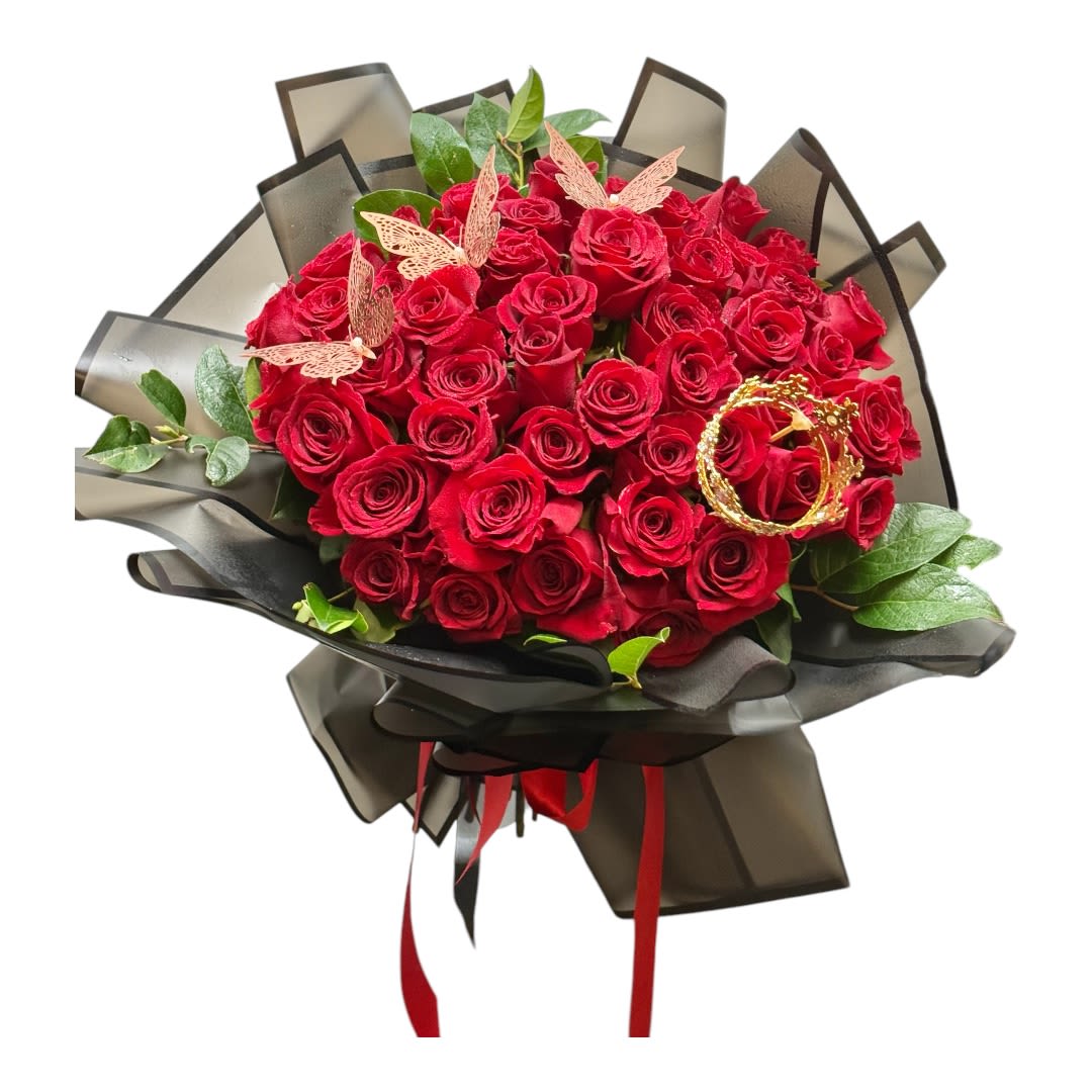 Bouquet of red roses wrapped in black paper with ribbon and butterfly accents