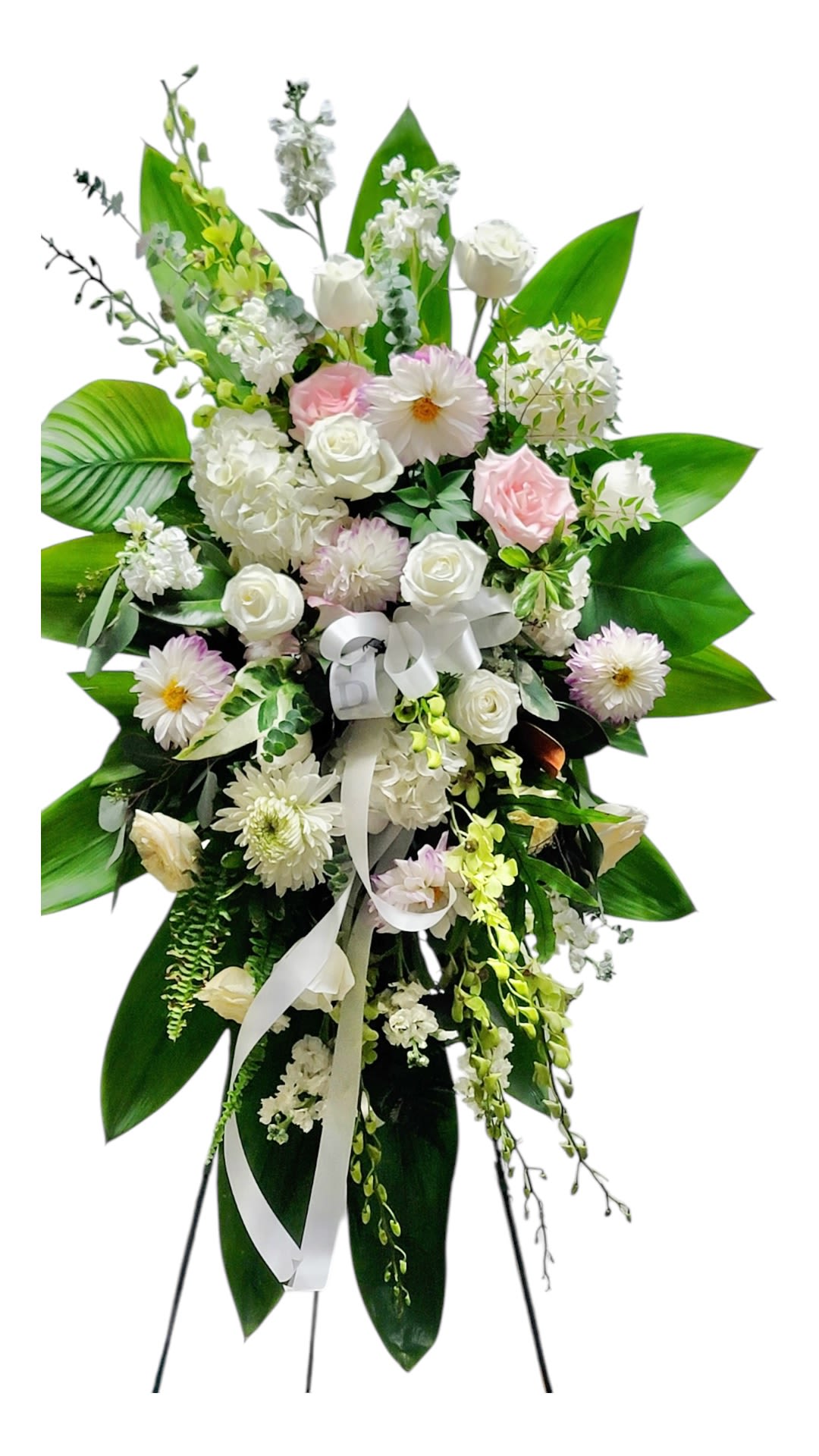 Standing floral spray with white and pale pink flowers on a white ribbon