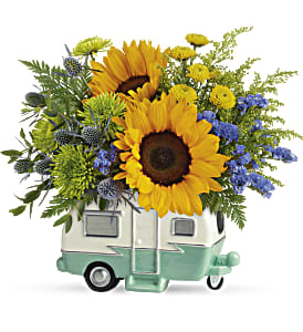 Sunflower arrangement in a small camper-shaped container