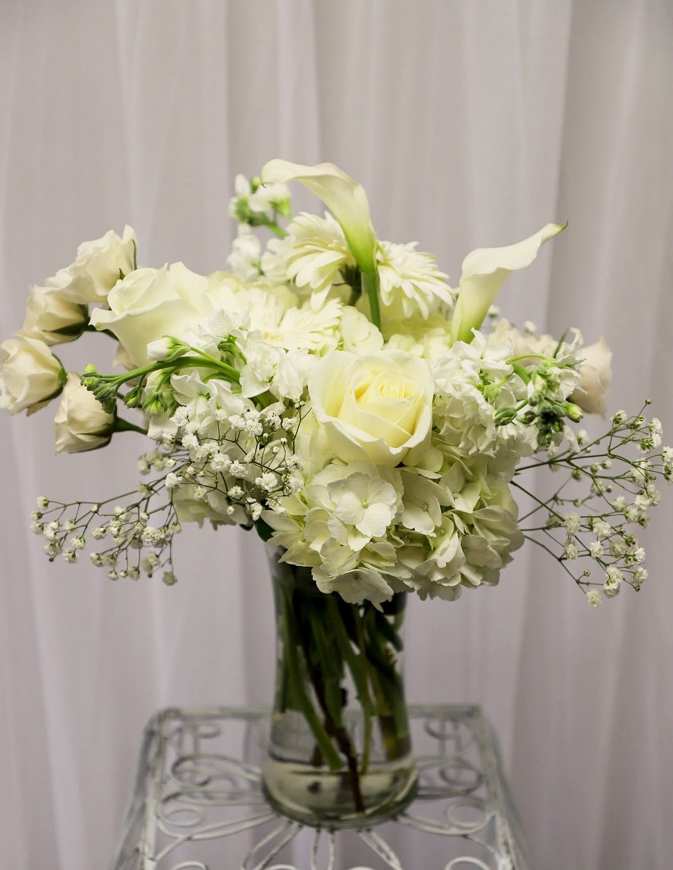 White floral arrangement in a clear glass vase