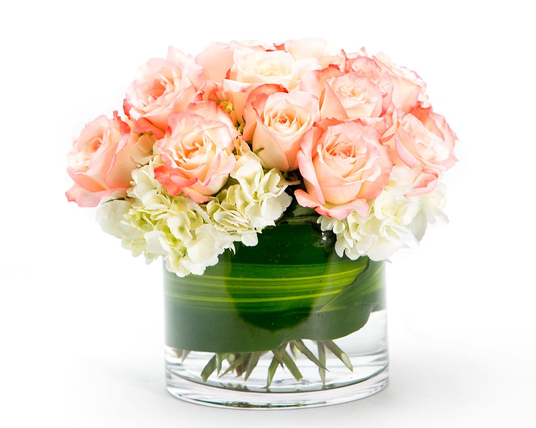 Pink roses and white hydrangeas in a glass vase